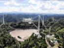 The instrument platform, still suspended above the Arecibo Observatory dish, which was damaged when a cable broke earlier this year.